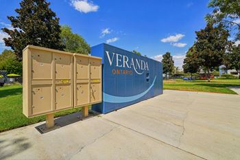 A sign that says Veranda Ontario stands in front of a row of portable toilets.